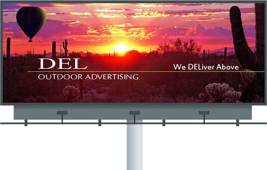 Large billboard on a single pole showing the Del Outdoor Advertising desert sunset design