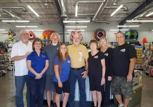Group of eight people standing together inside a store